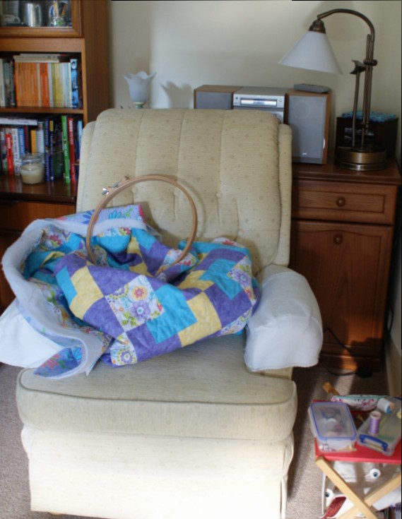 Quilt patiently awaiting some attention in my thoughtful chair!