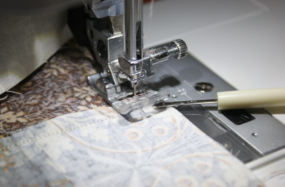 And finally, a little tip. To stop seams flipping back as they pass under the machine foot, use a seam ripper to press down the seam as it travels under the foot.