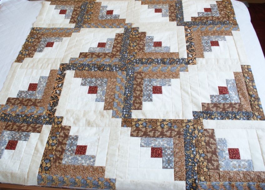 The sixteen 14" log cabin blocks sewn together in a whirligig pattern.