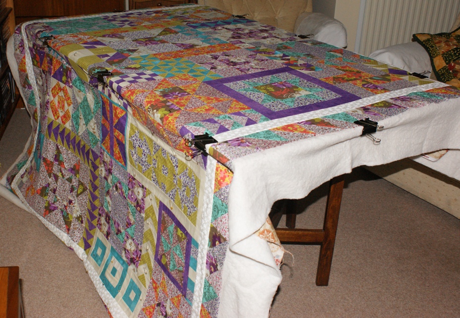 I use an old gate-leg and a set of giant bulldog clips rather than the floor and masking tape when making a quilt sandwich - kinder on my knees and back!
