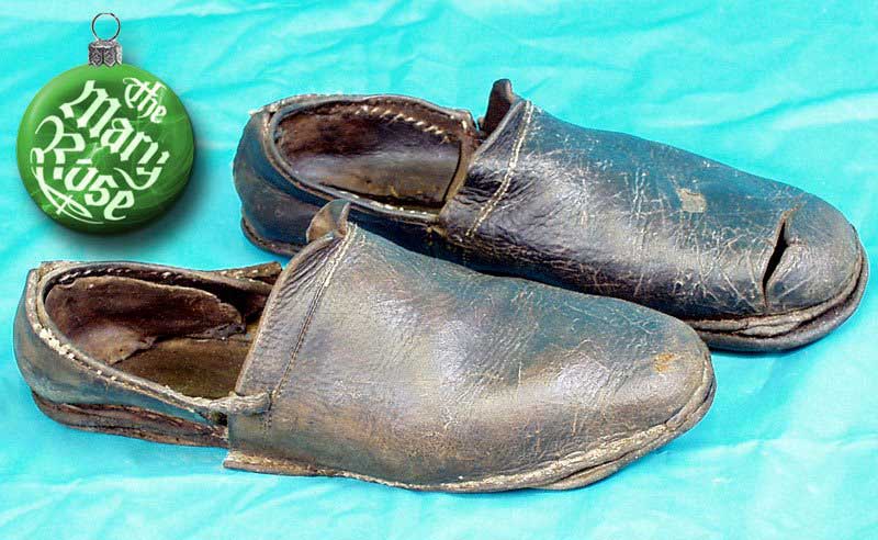A pair of workman's shoes. No left or right and with very smooth soles many sailors shoes were stored below decks whie they worked barefoot on the slippery decks.