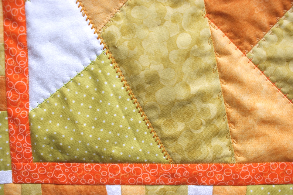 I had fun trying out the fancy stitches my machine can produce. I used several toning cotton threads to add more variety tot he quilting.