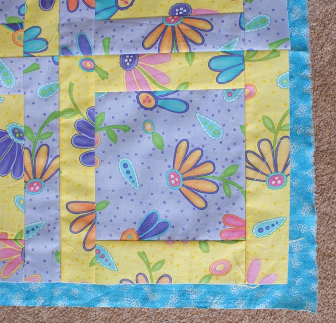 I'll be using the turquoise fabric to back and bind this little quilt - a decision made!