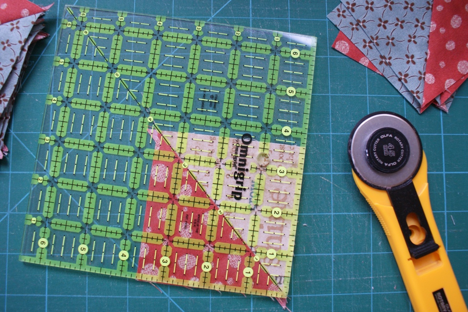 Squaring up HST blocks.  For this project I gave myself a bit of wiggle room and cut the squares 1" larger than the finished size of the block rather than the 7/8ths actually required to make the finished size.
