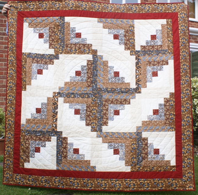 The blocks are set in a 'whirligig' pattern and I quilted using a continuous spiral.  The quilt measures about 68" square.   