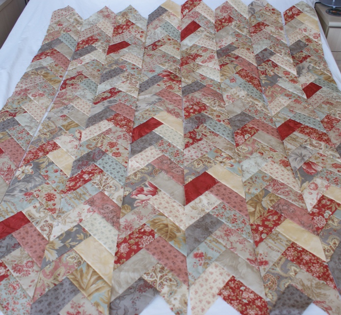 The eight braid strips ready to be sewn together before trimming the excess fabric top and bottom.