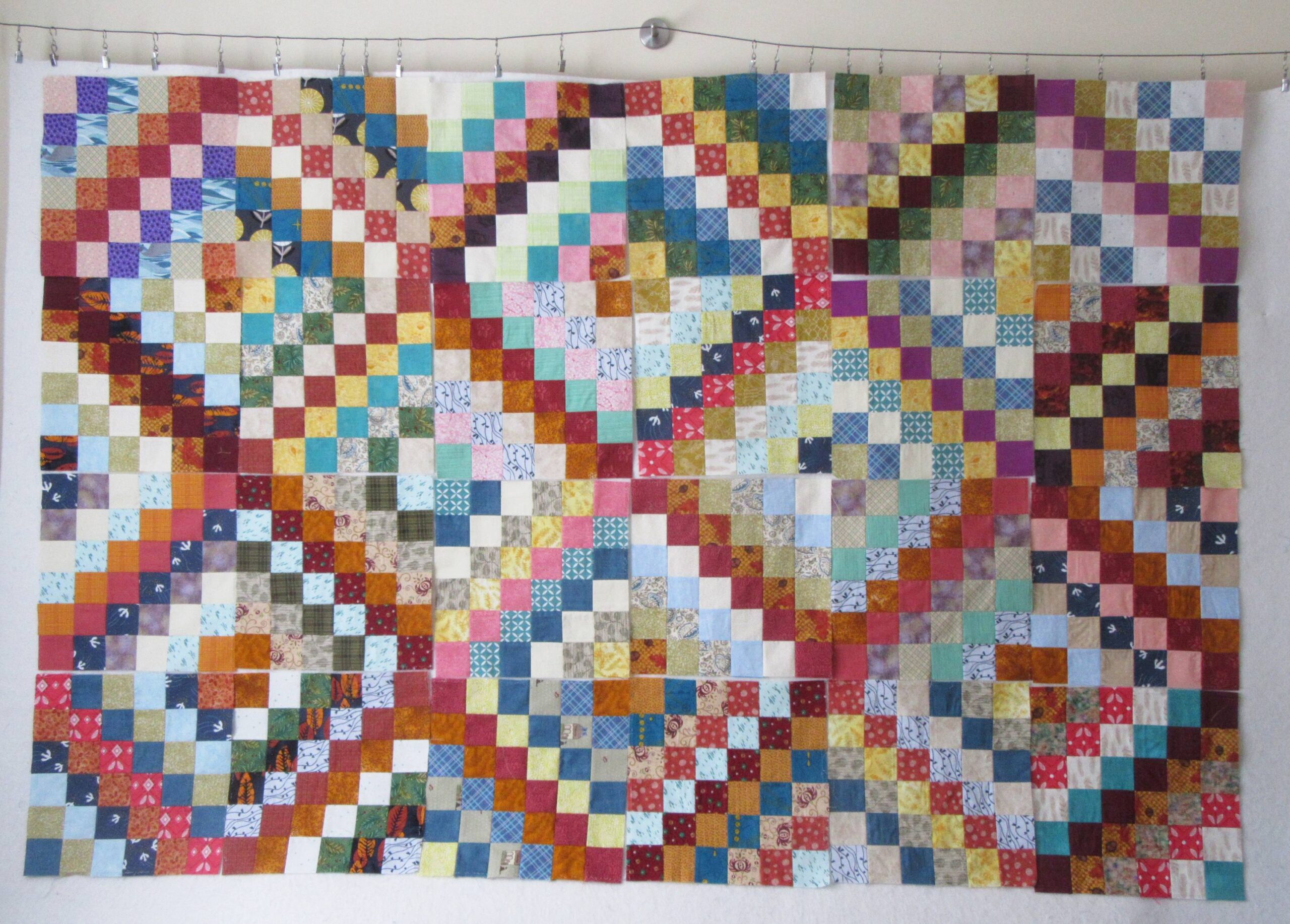 Scrappy Trip Along blocks on design wall by Allison Reid