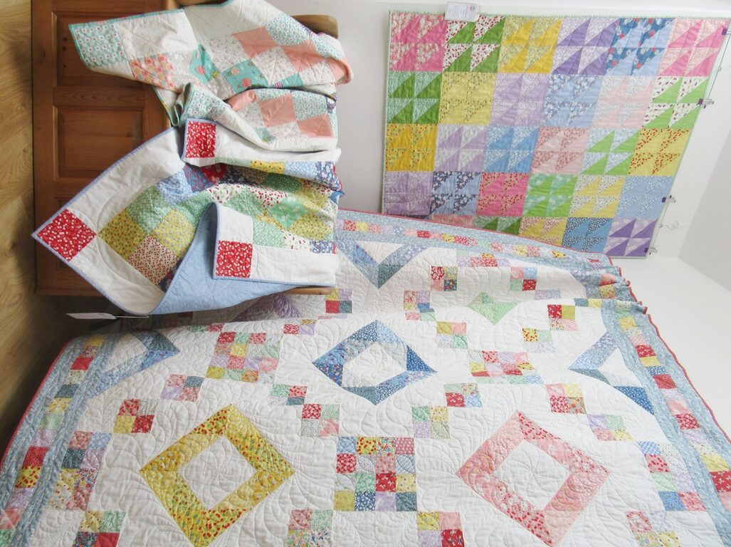 Quilts in the lobby by Allison Reid